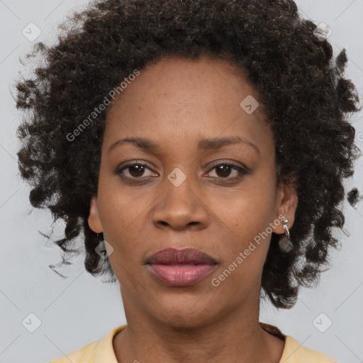 Joyful black adult female with medium  brown hair and brown eyes