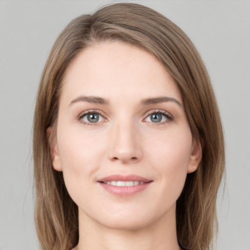 Joyful white young-adult female with long  brown hair and green eyes