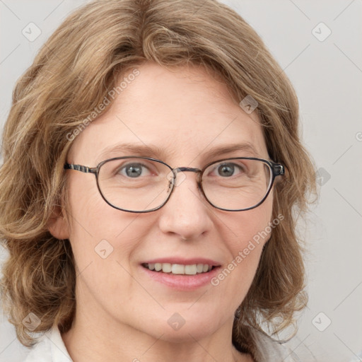 Joyful white adult female with medium  brown hair and blue eyes