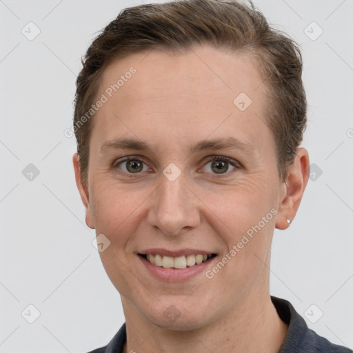 Joyful white young-adult female with short  brown hair and grey eyes