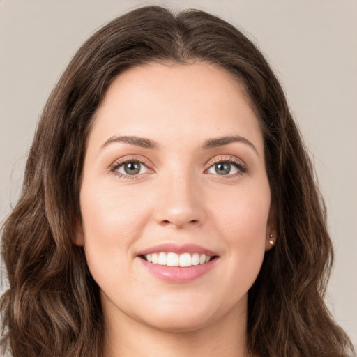 Joyful white young-adult female with long  brown hair and green eyes