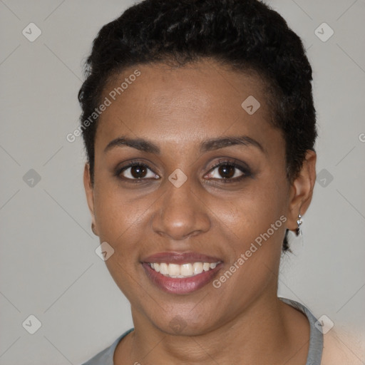 Joyful black young-adult female with short  brown hair and brown eyes