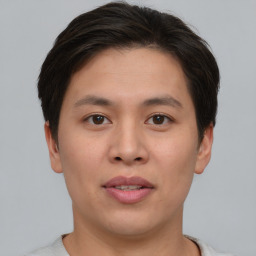 Joyful asian young-adult male with short  brown hair and brown eyes