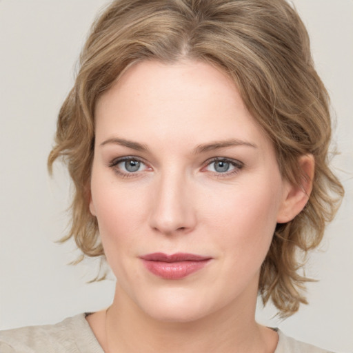 Joyful white young-adult female with medium  brown hair and blue eyes