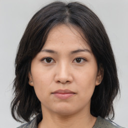 Neutral asian young-adult female with medium  brown hair and brown eyes