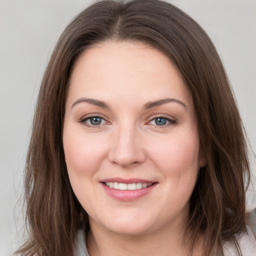 Joyful white young-adult female with long  brown hair and grey eyes