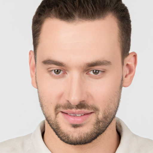 Joyful white young-adult male with short  brown hair and brown eyes