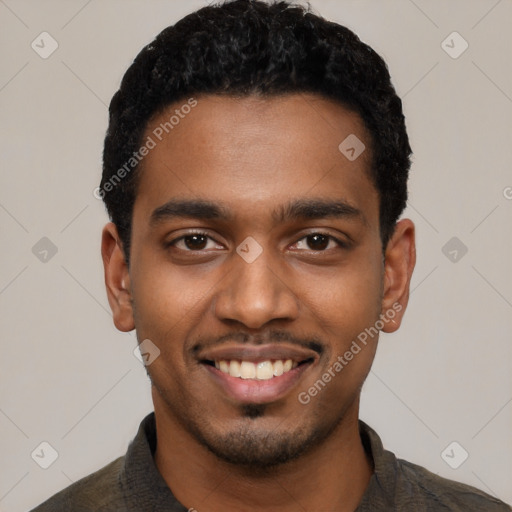 Joyful black young-adult male with short  black hair and brown eyes