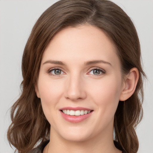 Joyful white young-adult female with medium  brown hair and green eyes