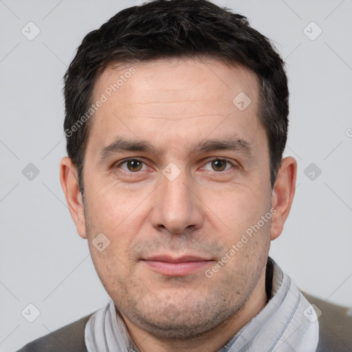 Joyful white adult male with short  brown hair and brown eyes