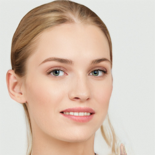 Joyful white young-adult female with long  brown hair and blue eyes