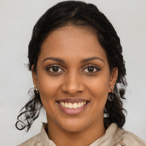 Joyful black young-adult female with long  brown hair and brown eyes