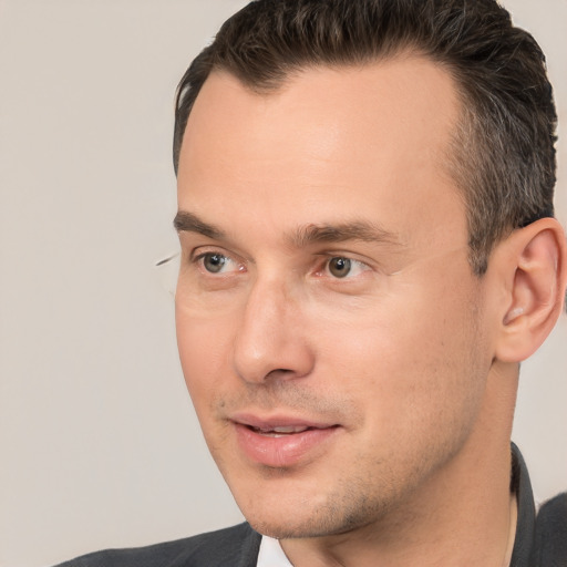 Joyful white adult male with short  brown hair and brown eyes