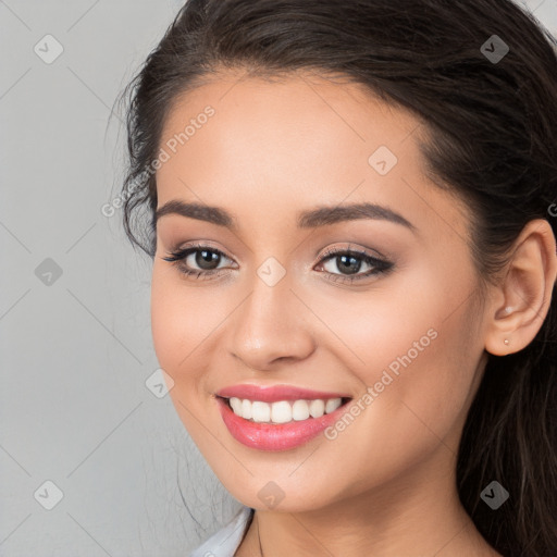 Joyful white young-adult female with long  brown hair and brown eyes