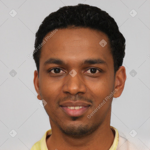 Joyful black young-adult male with short  black hair and brown eyes