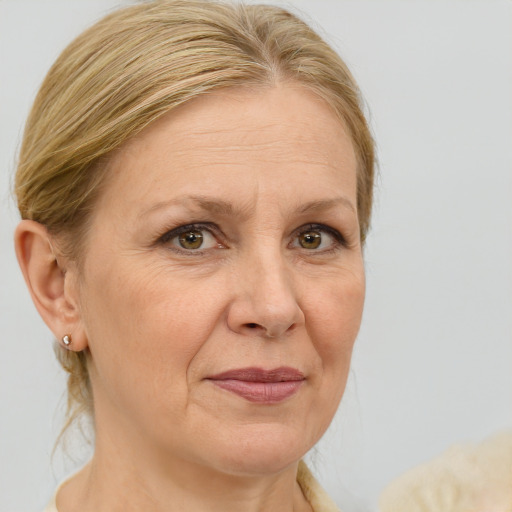 Joyful white adult female with medium  brown hair and blue eyes