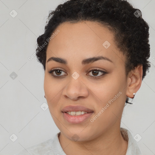 Joyful black young-adult female with short  black hair and brown eyes