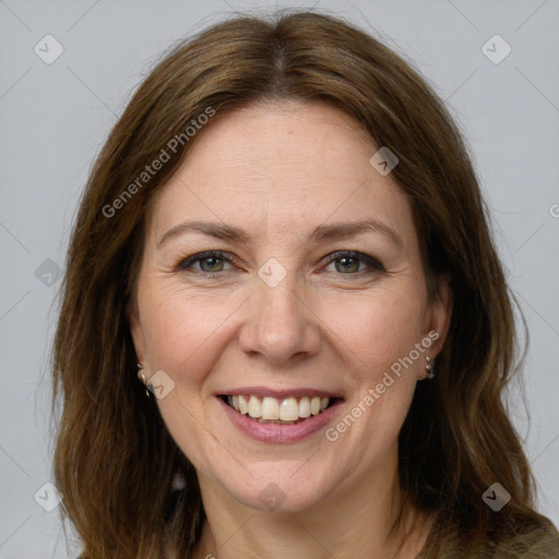 Joyful white adult female with medium  brown hair and grey eyes