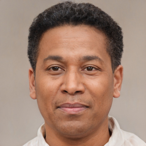 Joyful latino adult male with short  brown hair and brown eyes