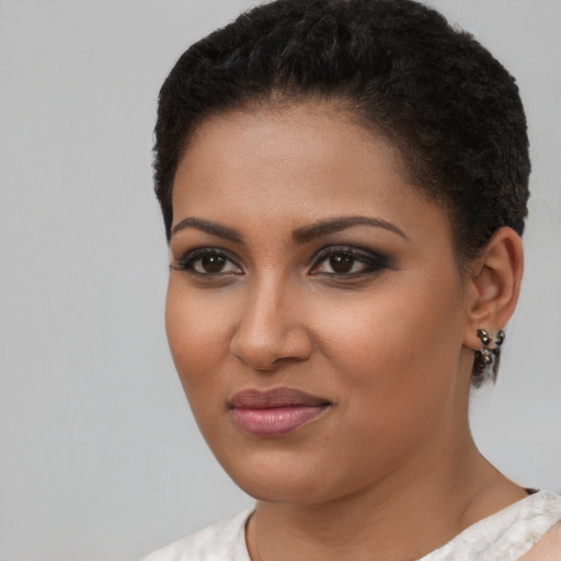 Joyful black young-adult female with short  brown hair and brown eyes