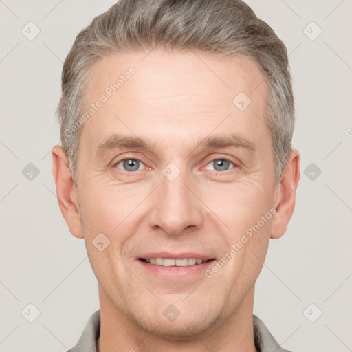 Joyful white adult male with short  brown hair and grey eyes