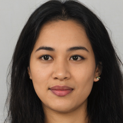 Joyful asian young-adult female with long  black hair and brown eyes