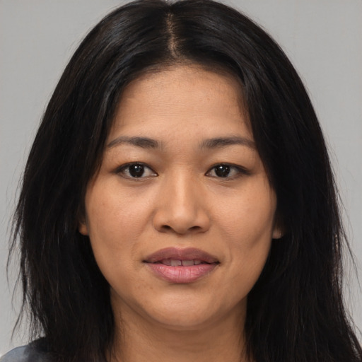 Joyful asian young-adult female with long  black hair and brown eyes