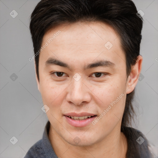 Joyful asian young-adult male with short  brown hair and brown eyes