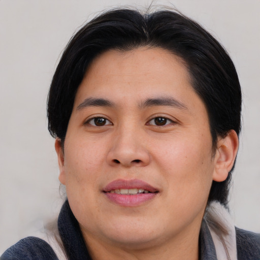 Joyful asian young-adult male with medium  brown hair and brown eyes