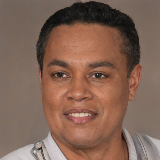 Joyful latino adult male with short  black hair and brown eyes