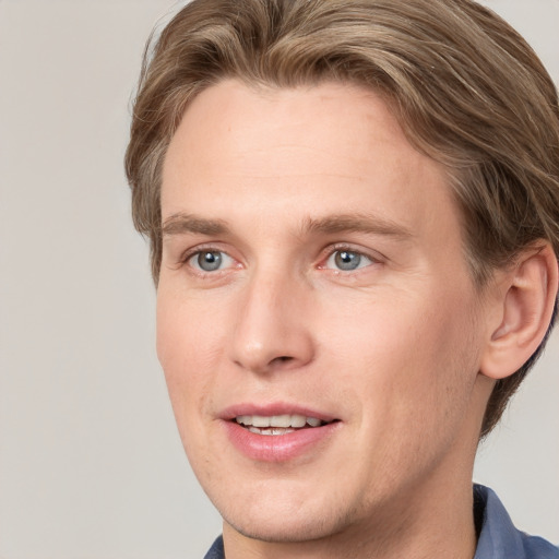 Joyful white adult male with short  brown hair and grey eyes