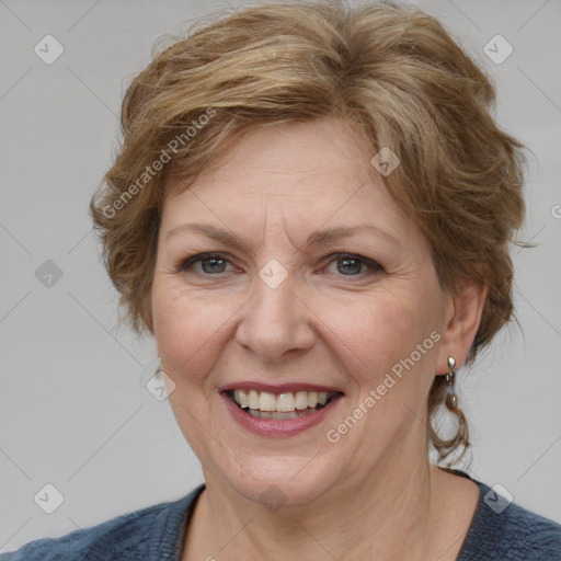 Joyful white adult female with medium  brown hair and blue eyes