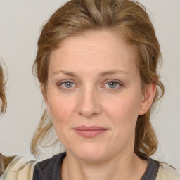 Joyful white young-adult female with medium  brown hair and blue eyes