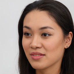 Joyful asian young-adult female with long  brown hair and brown eyes