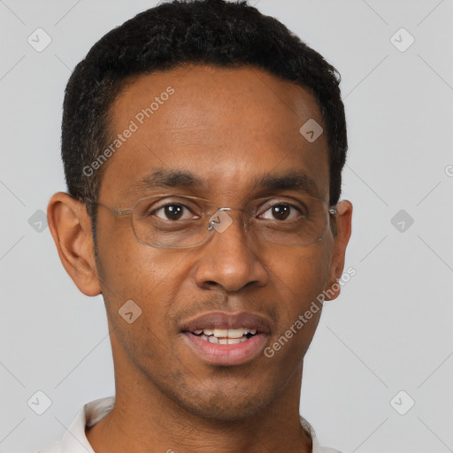 Joyful black young-adult male with short  brown hair and brown eyes