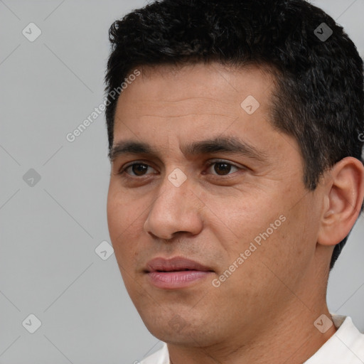 Joyful white young-adult male with short  black hair and brown eyes