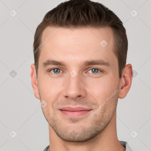 Joyful white young-adult male with short  brown hair and grey eyes