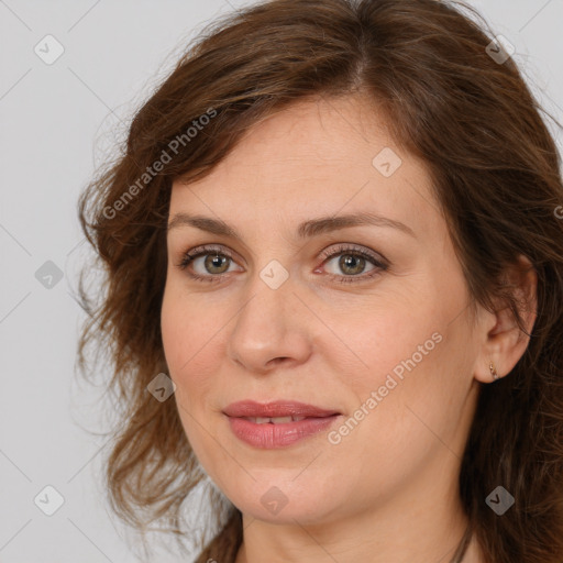 Joyful white adult female with long  brown hair and brown eyes