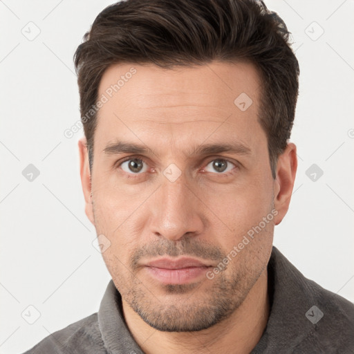 Joyful white adult male with short  brown hair and brown eyes