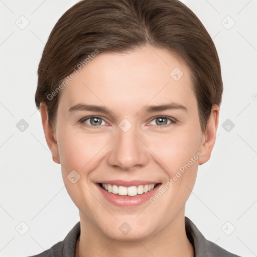 Joyful white young-adult female with short  brown hair and grey eyes