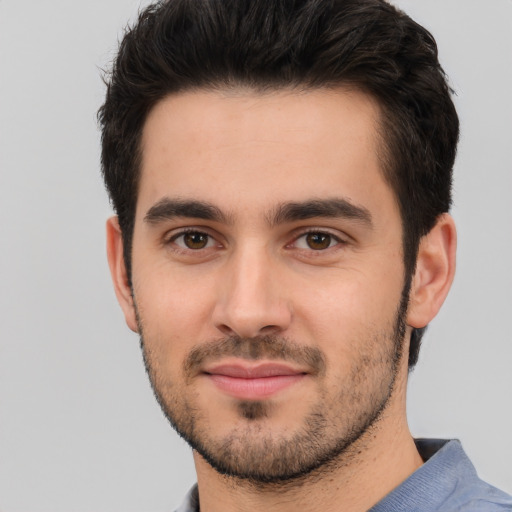 Joyful white young-adult male with short  black hair and brown eyes