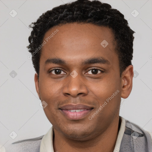 Joyful black young-adult male with short  brown hair and brown eyes