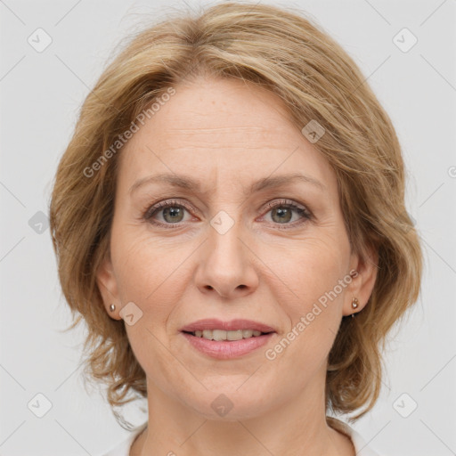 Joyful white adult female with medium  brown hair and grey eyes