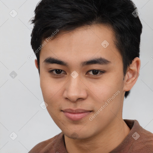 Joyful asian young-adult male with short  brown hair and brown eyes