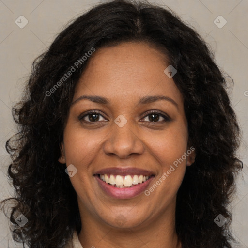 Joyful black young-adult female with long  brown hair and brown eyes