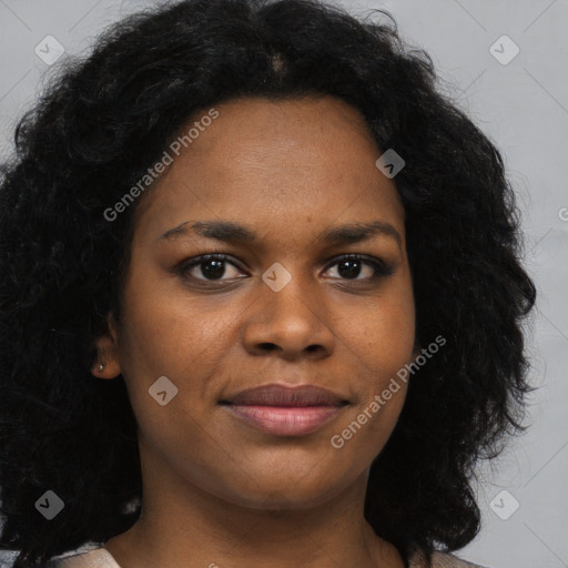 Joyful black young-adult female with long  brown hair and brown eyes