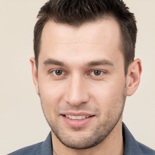 Joyful white young-adult male with short  brown hair and brown eyes