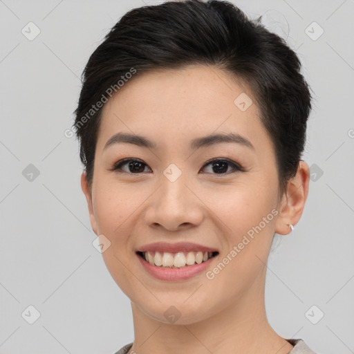 Joyful asian young-adult female with short  brown hair and brown eyes