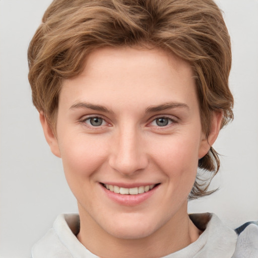 Joyful white young-adult female with short  brown hair and grey eyes