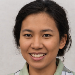 Joyful asian young-adult female with medium  brown hair and brown eyes